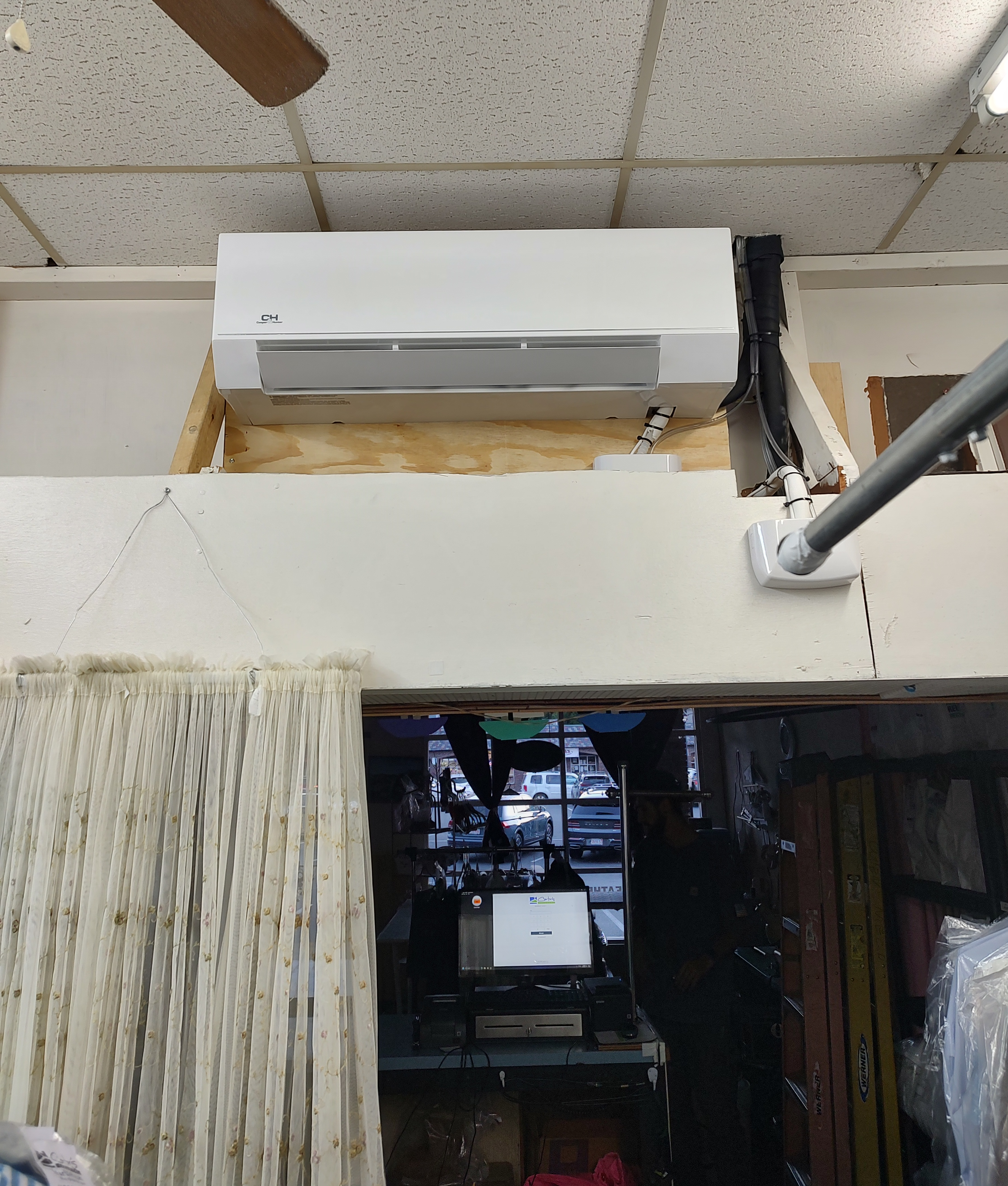 A brand new ductless mini split installed in the back room of an office space.